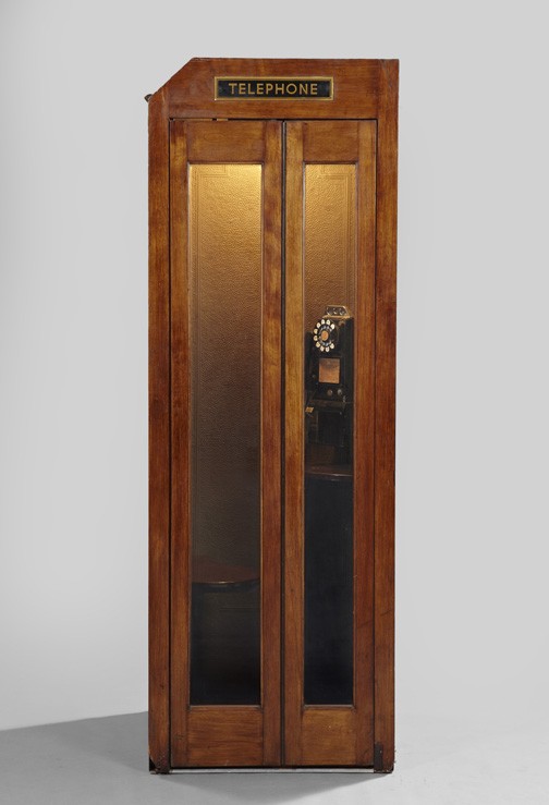 Interesting Stained Birch Telephone Booth,: Interesting Stained Birch Telephone Booth, second quarter 20th century, the folding door opening to an interior fitted with a small bench and a rotary pay phone, h. 83-1/2", w. 29", d. 30".