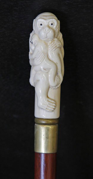 Anglo-Chinese Ivory and Brass Mahogany Walking St: Anglo-Chinese Carved Ivory and Brass Mounted Mahogany Walking Stick, the ivory grip in the form of cuddling monkeys, mounted to a brass collar and ending in a brass ferrule, h. 36".