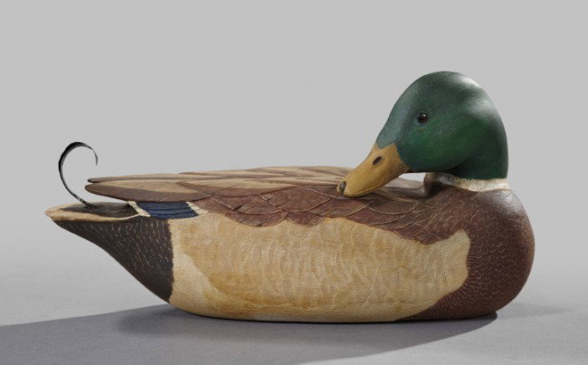 William Young (American, 1922-2008),: William Young (American, 1922-2008), a carved, polychromed and wrought tin-mounted wooden decoy of a mallard drake, 1991, the side-turned head fitted with glass eyes, signed on the base "Wm.Young/1991