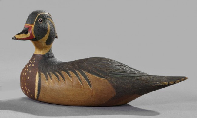William Young (American, 1922-2008),: William Young (American, 1922-2008), a carved and polychromed wood decoy of a wood duck, 1982, the head fitted with glass eyes, signed on the base "Wm.Young/1982/#11", h. 6", w. 5", l. 11".