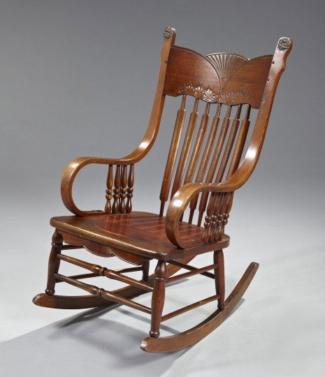 American Victorian Walnut Rocker,: American Victorian Walnut Rocker, fourth quarter 19th century, the shaped foliate- and shell-carved crest over the spindled back, joined to the seat by bentwood arms headed by rosette carvings, raised