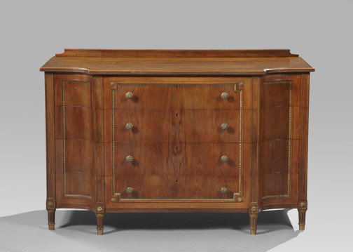 Louis XVI-Style Circassian Walnut Commode,: Louis XVI-Style Circassian Walnut Commode, the shaped rectangular top surmounted by a like backsplash, over a conforming case fitted with four long drawers, raised on fluted tapering circular legs end