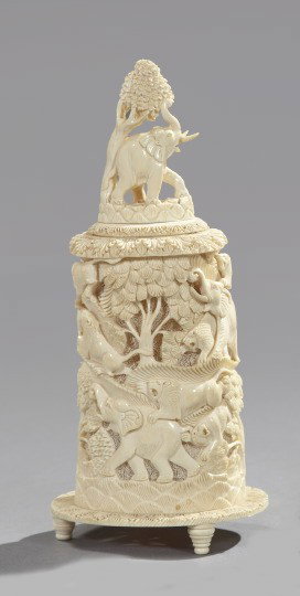 Indian Carved Ivory Group,: Indian Carved Ivory Group, mid-20th century, in the form of a cylindrical tower depicting a jungle scene with elephants, lions, giraffes and trees, h. 11-1/2", dia. 4-1/2".