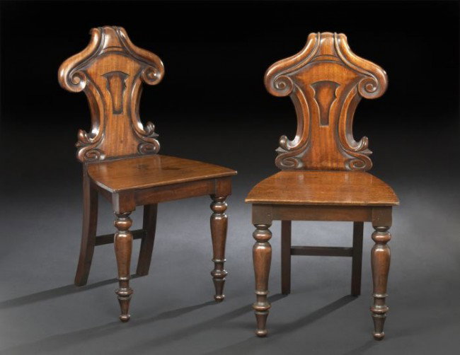Pair of William IV-Style Mahogany Hall Chairs: Pair of William IV-Style Mahogany Hall Chairs, each with a scrolling modified shield-form back above the wooden seat, raised on turned and tapering bulbous legs ending in toupie feet, h. 32-1/2".