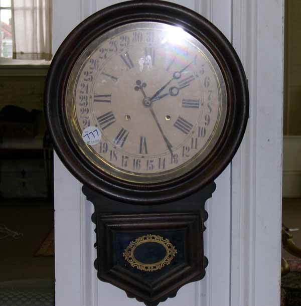 AMERICAN EGLOMISE WALL CLOCK: Attractive American Turned and Walnut-Stained Ashwood and Églomisé Wall Clock, of "Parliament" form, fourth quarter 19th century, the large circular dial in antique white, with a double register of
