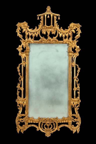 English Carved Giltwood Mirror: Large and Attractive English Carved Giltwood Looking Glass, in the style of Thomas Johnson (1714 -1778), the cresting modeled as a Chinese pavilion, its eaves dressed with articulated giltwood bells,