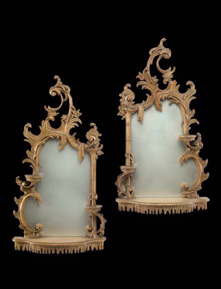 English Wood Girandole Shelves: Pair of English Carved, Fruitwood-Stained and Pickled Wood Girandole Shelves, in the style of Thomas Johnson (English, 1714 -1778), the bowfront shelves with "icicle"-carved aprons, the backplates mir