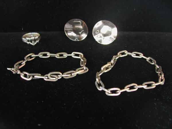 Four-Piece Group of Silver Jewelry: Four-Piece Group of Silver Jewelry, composed of two oval-link bracelets, a pair of disc -shaped earrings and a ring with heart and cross motif.