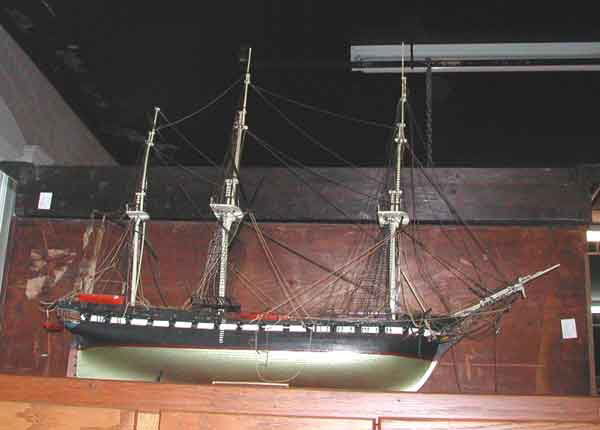 Two Wooden Ship Models: Two Wooden Ship Models, one a finely crafted and highly detailed large wooden model of the "USS Constitution" ("Old Ironsides") h. 25", and a good polychromed wooden model of a Chesapeake Bay skiff, h