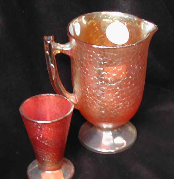 Ten-Piece Beverages Set: Ten-Piece Beverages Set, consisting of an Imperial Glass Company marigold Carnival glass footed iced beverages pitcher in "Spider Wed and Soda" decor, and a set of nine matching tapering goblets, all