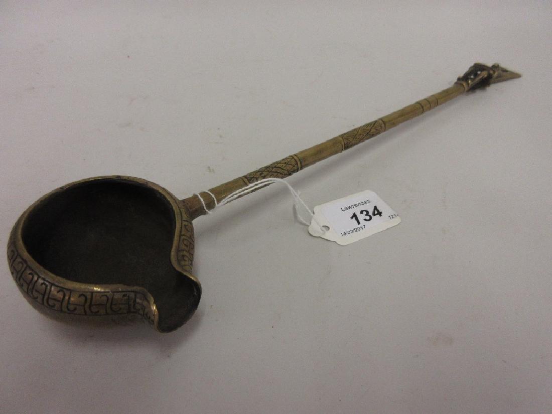 Tibetan engraved bronze water pourer with figural (1 of 1)