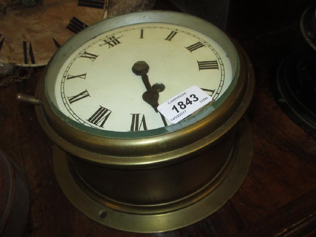 Brass cased ship's bulk head clock, the enamel dial (1 of 1)