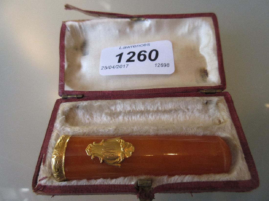 Gold mounted amber cigar case: Gold mounted amber cigar case