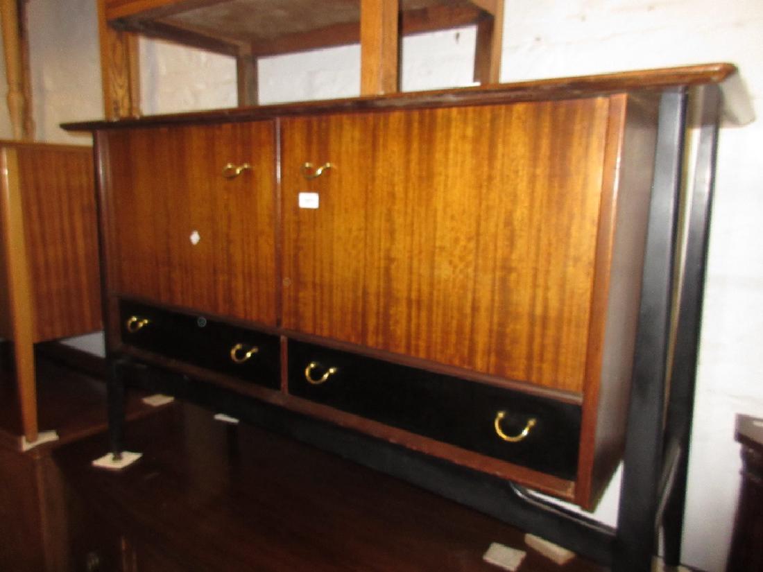 1970's G-Plan ebonised and mahogany sideboard having: 1970's G-Plan ebonised and mahogany sideboard having two flush panelled doors above two drawers with ebonised splay supports
