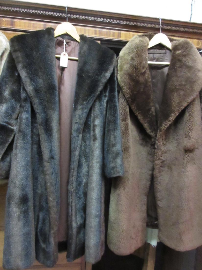 Group of four synthetic fur coats and a bag containing (1 of 2)