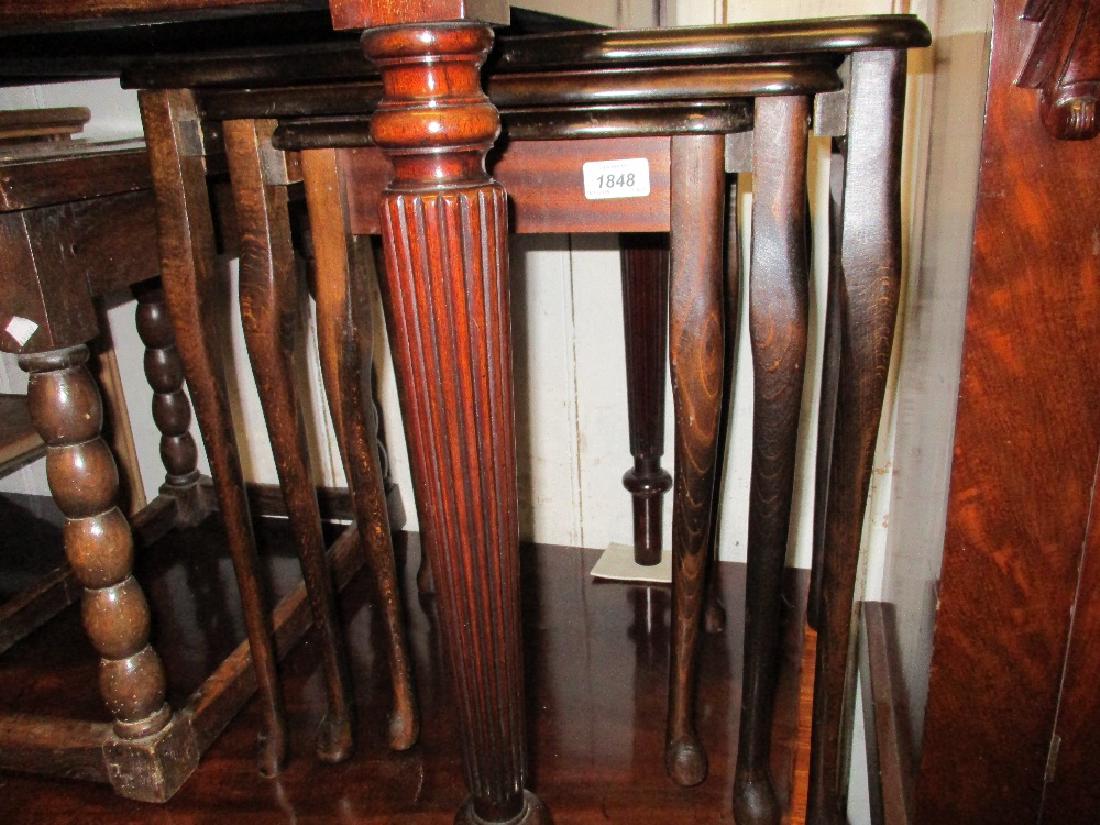 Nest of three shaped rectangular mahogany coffee tables: Nest of three shaped rectangular mahogany coffee tables on cabriole supports, together with a rectangular upholstered footstool on claw and ball supports