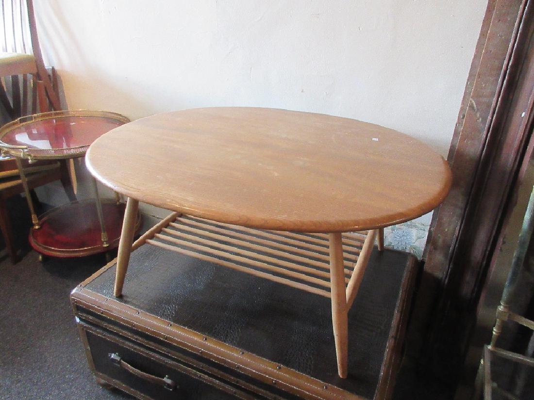 20th Century light ash Ercol oval coffee table with: 20th Century light ash Ercol oval coffee table with undertier on splay supports