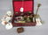 Red leather jewellery box containing a quantity of