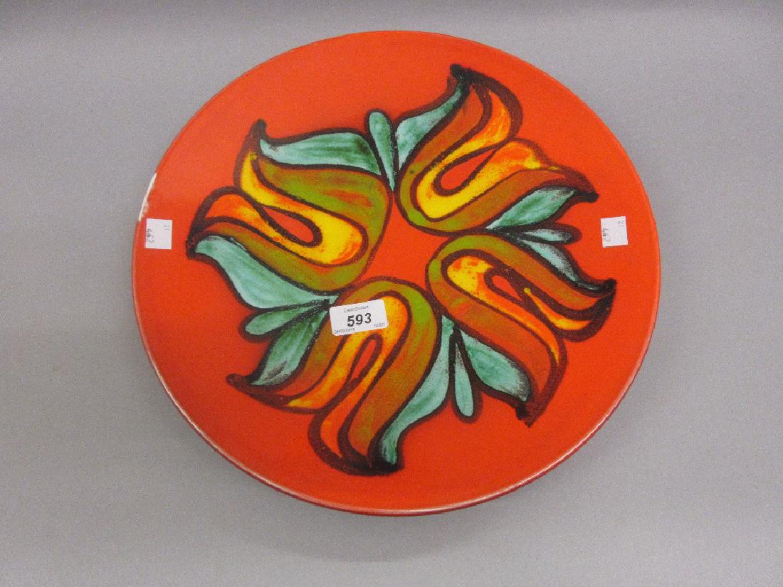 Poole Pottery charger decorated in blue, green and: Poole Pottery charger decorated in blue, green and yellow on orange ground