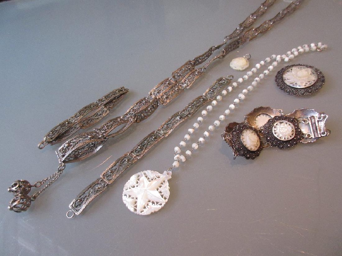 Two Armenian filigree bracelets and a similar belt,: Two Armenian filigree bracelets and a similar belt, silver and mother of pearl bracelet with matching brooch, a mother of pearl necklet and a Bethlehem mother of pearl pendant