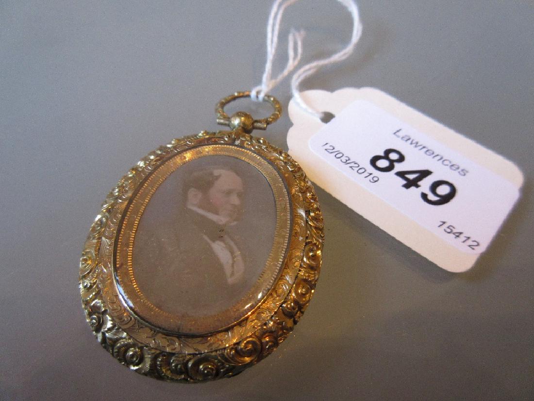 Early Victorian oval gilt metal pendant locket inset: Early Victorian oval gilt metal pendant locket inset with a double sided portrait, Daguerreotype