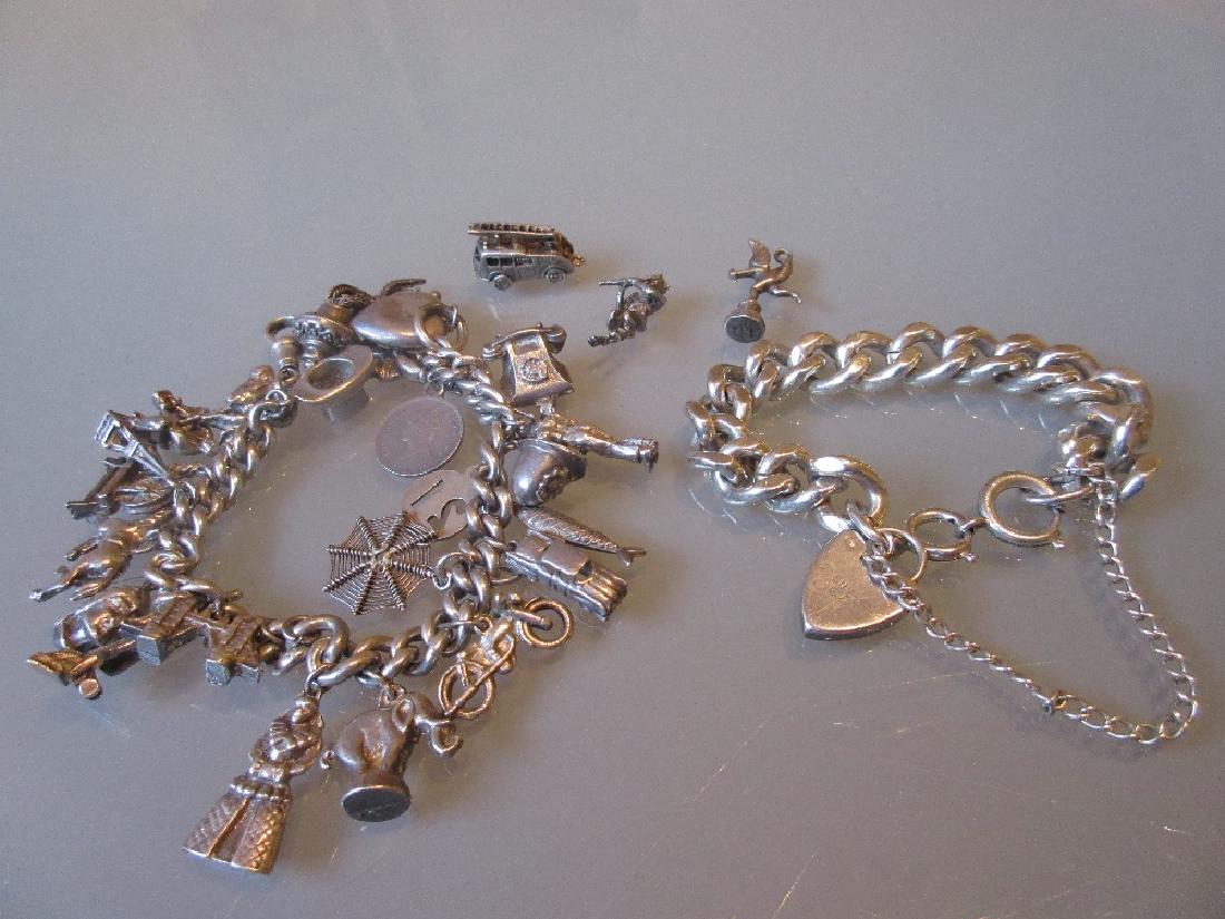 Silver charm bracelet with twenty five plus silver: Silver charm bracelet with twenty five plus silver charms including fire engine, animals, spinning wheel, figures etc., together with a silver chain link bracelet with heart form clasp