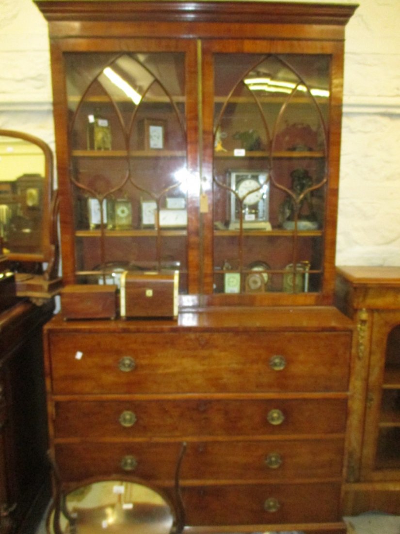 George III mahogany secretaire bookcase, the moulded: George III mahogany secretaire bookcase, the moulded cornice above a pair of shaped bar glazed doors enclosing shelves, the base with a fitted secretaire drawer above three further drawers with brass 