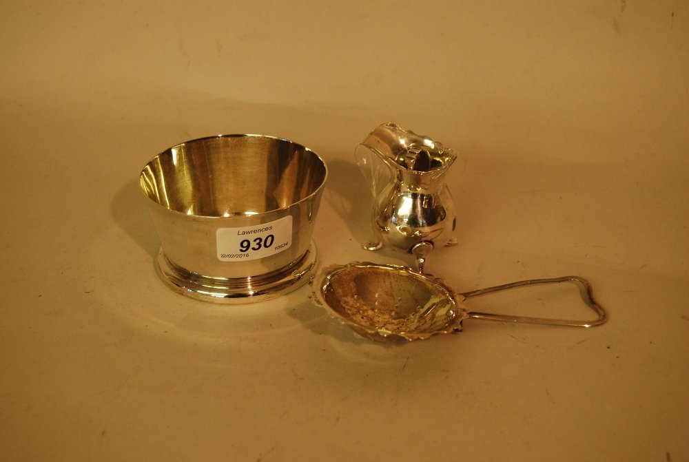 A.E. Jones, Birmingham silver sugar basin together with: A.E. Jones, Birmingham silver sugar basin together with a small silver cream jug (a/f) and a silver tea strainer (a/f)