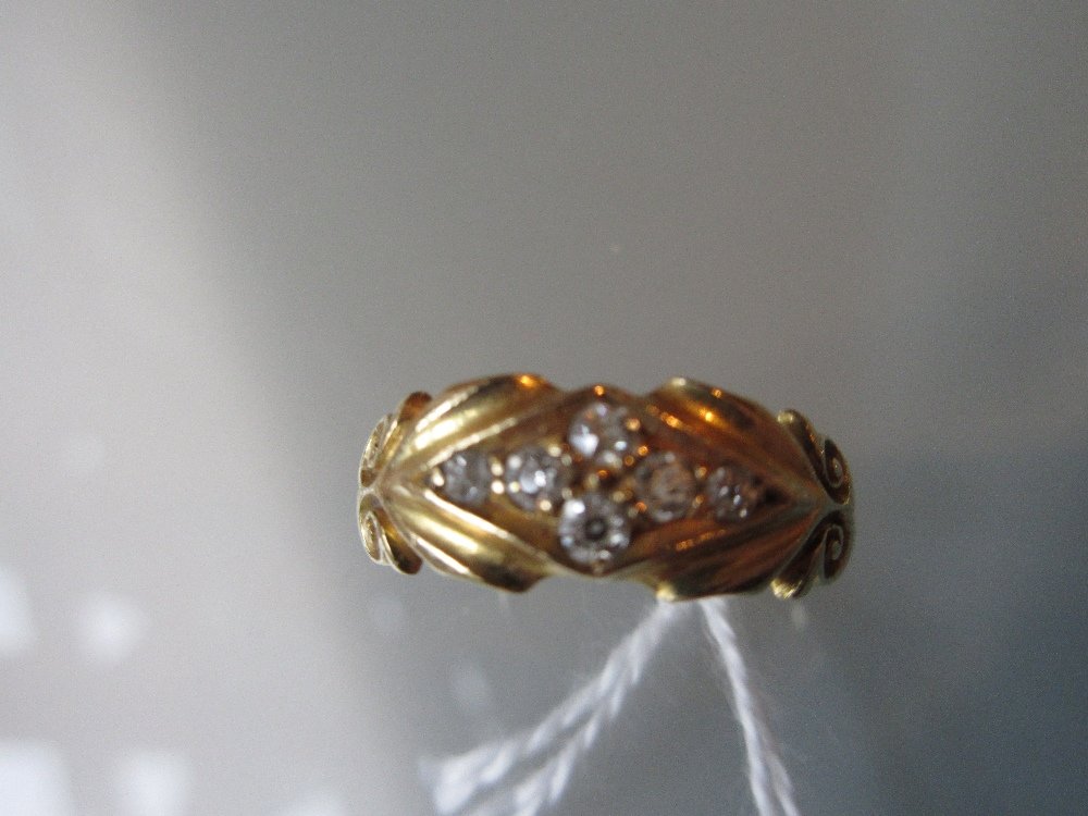 18ct Gold ring set six small diamonds in a carved (1 of 2)