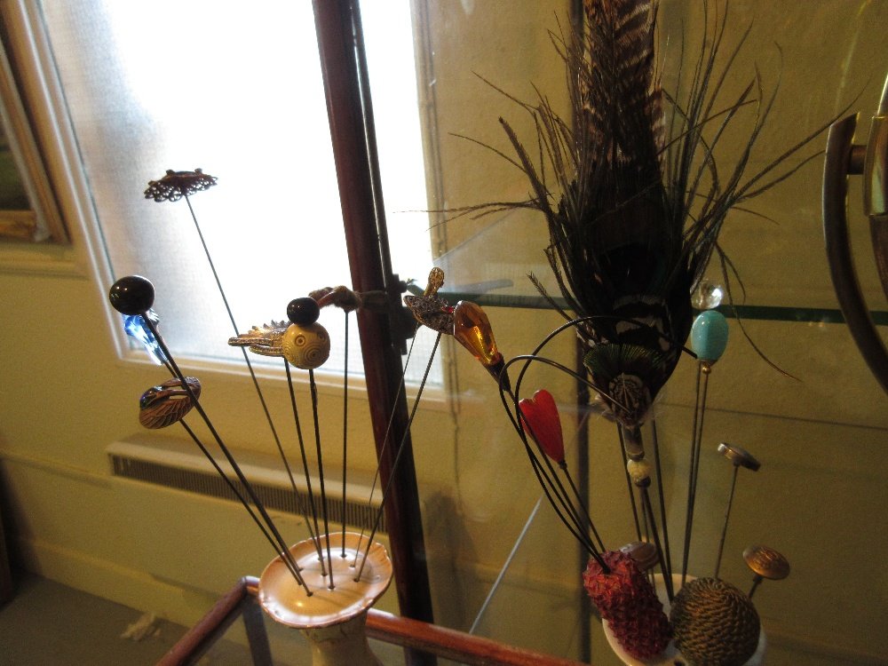 Three porcelain hat pin stands containing a quantity of (1 of 1)