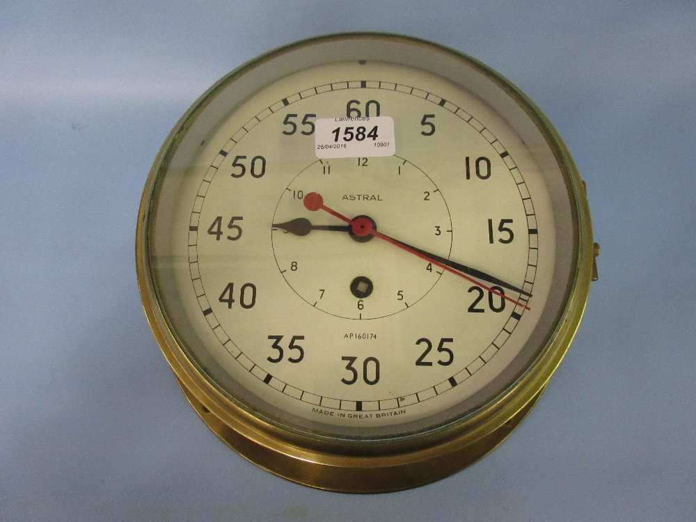 Brass cased ships bulk head clock by Astral, the: Brass cased ships bulk head clock by Astral, the painted dial with Arabic numerals and sweep seconds hand with a single train key wind movement