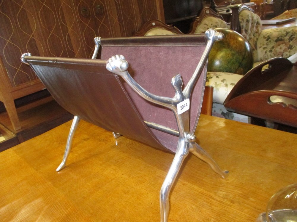 Carrol Boyes, late 20th Century aluminium and leather: Carrol Boyes, late 20th Century aluminium and leather magazine rack on figural supports
