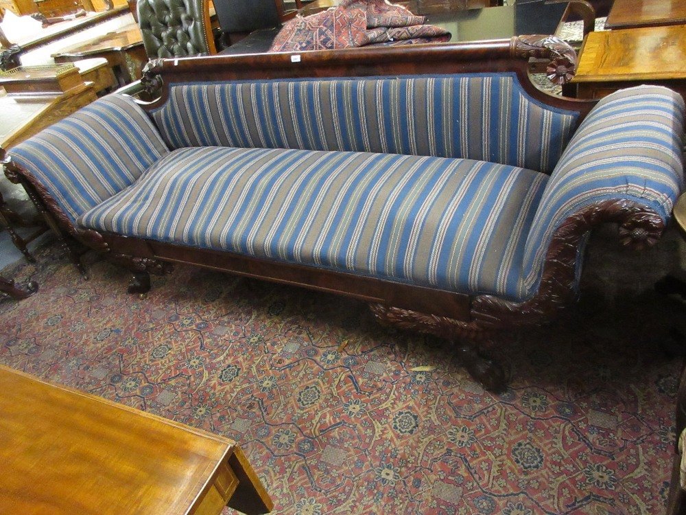 George IV mahogany sofa in the manner of Duncan Phyfe,: George IV mahogany sofa in the manner of Duncan Phyfe, the figured rail back and scroll ends with carved acanthus and floral decoration above a moulded frieze and carved cabriole paw supports, upholst