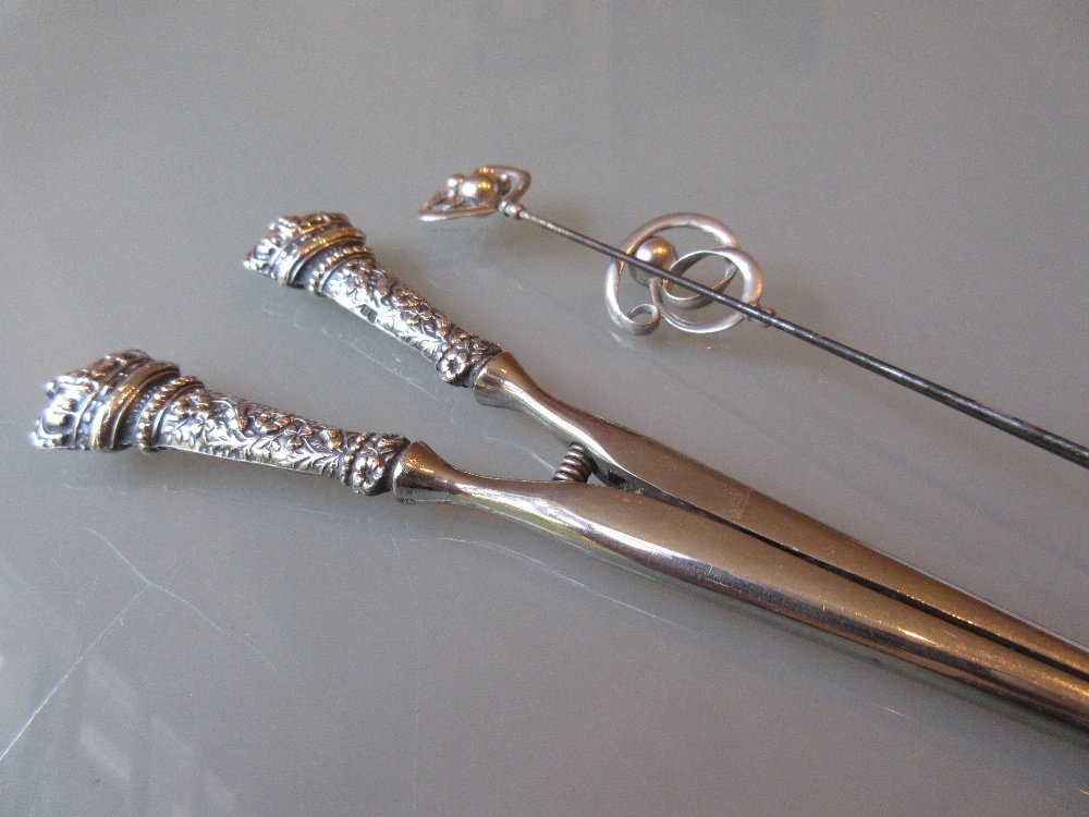 Two Charles Horner silver hat pins together with a pair: Two Charles Horner silver hat pins together with a pair of silver handled glove stretchers