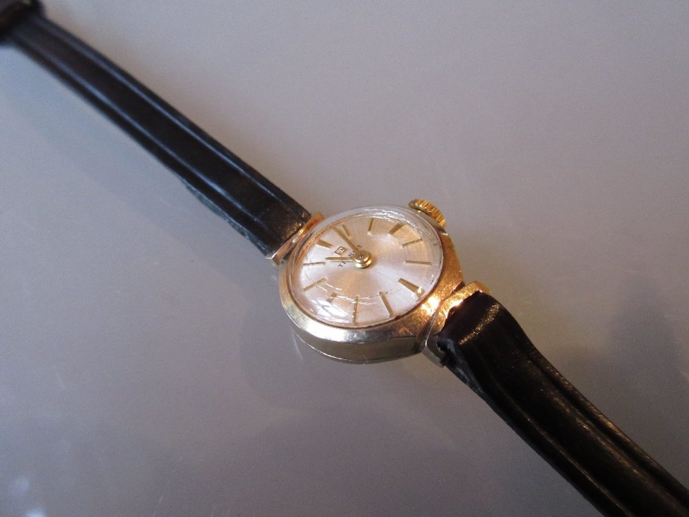 Ladies Tissot gold cased wristwatch with a black: Ladies Tissot gold cased wristwatch with a black leather strap