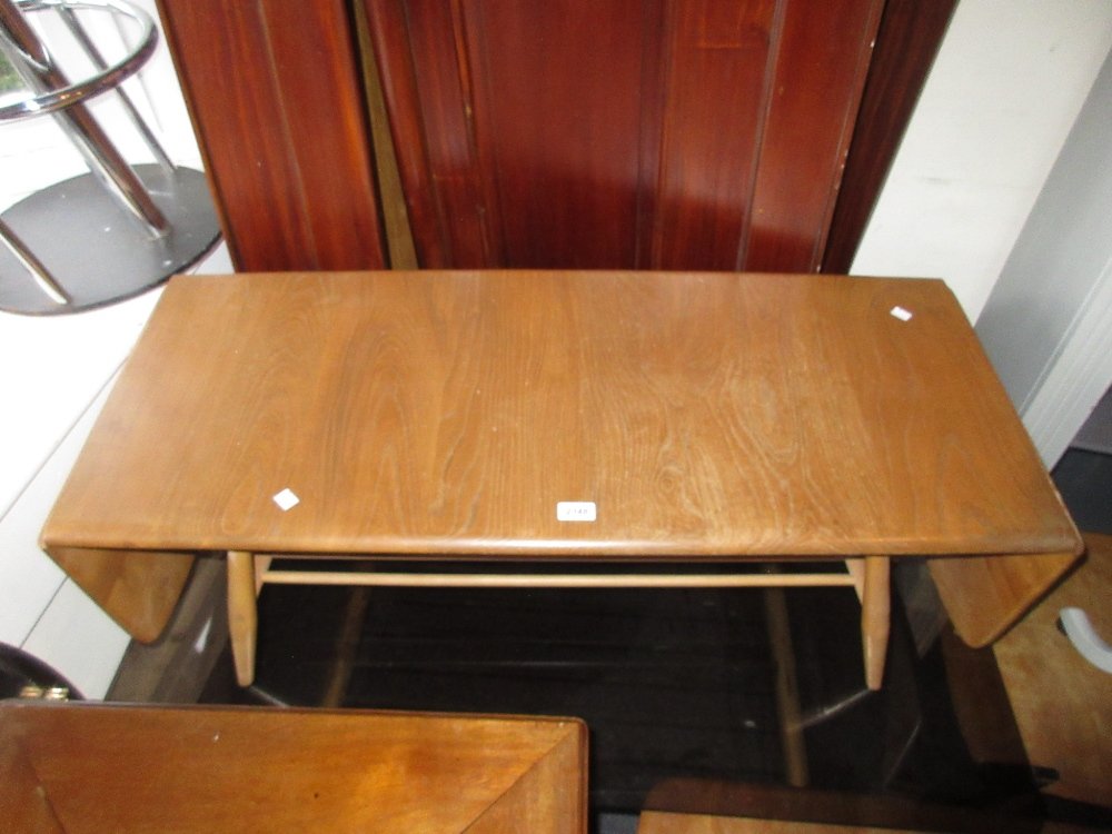 Ercol light ash and beech drop-leaf coffee table on: Ercol light ash and beech drop-leaf coffee table on turned supports with spindle stretchers