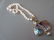 Abalone set silver pendant suspended from a cultured