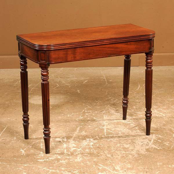 Sheraton mahogany lift top game table on turned and: Sheraton mahogany lift top game table on turned and fluted legs, c.1830, 35" long, 17" wide, 28" high, 33" wide when open