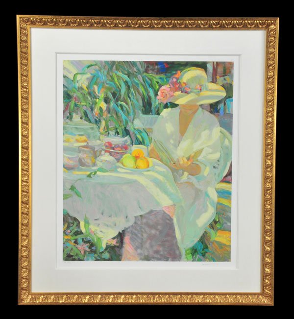 Framed lithograph of a lady seated at a table and