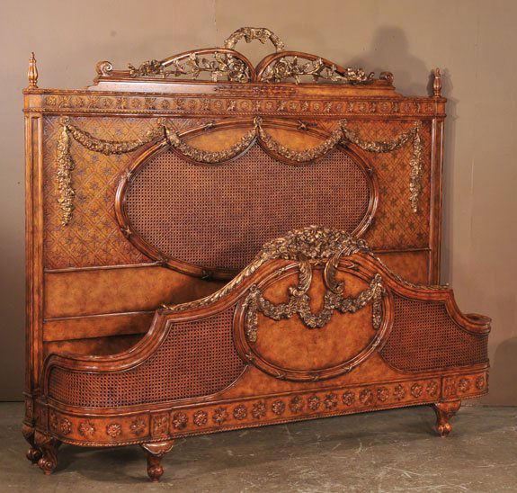 Louis XVI style walnut king sized bed with gold gi: Louis XVI style walnut king sized bed with gold gilt floral carvings and cane panels, 82" wide, 84" long, 68" high