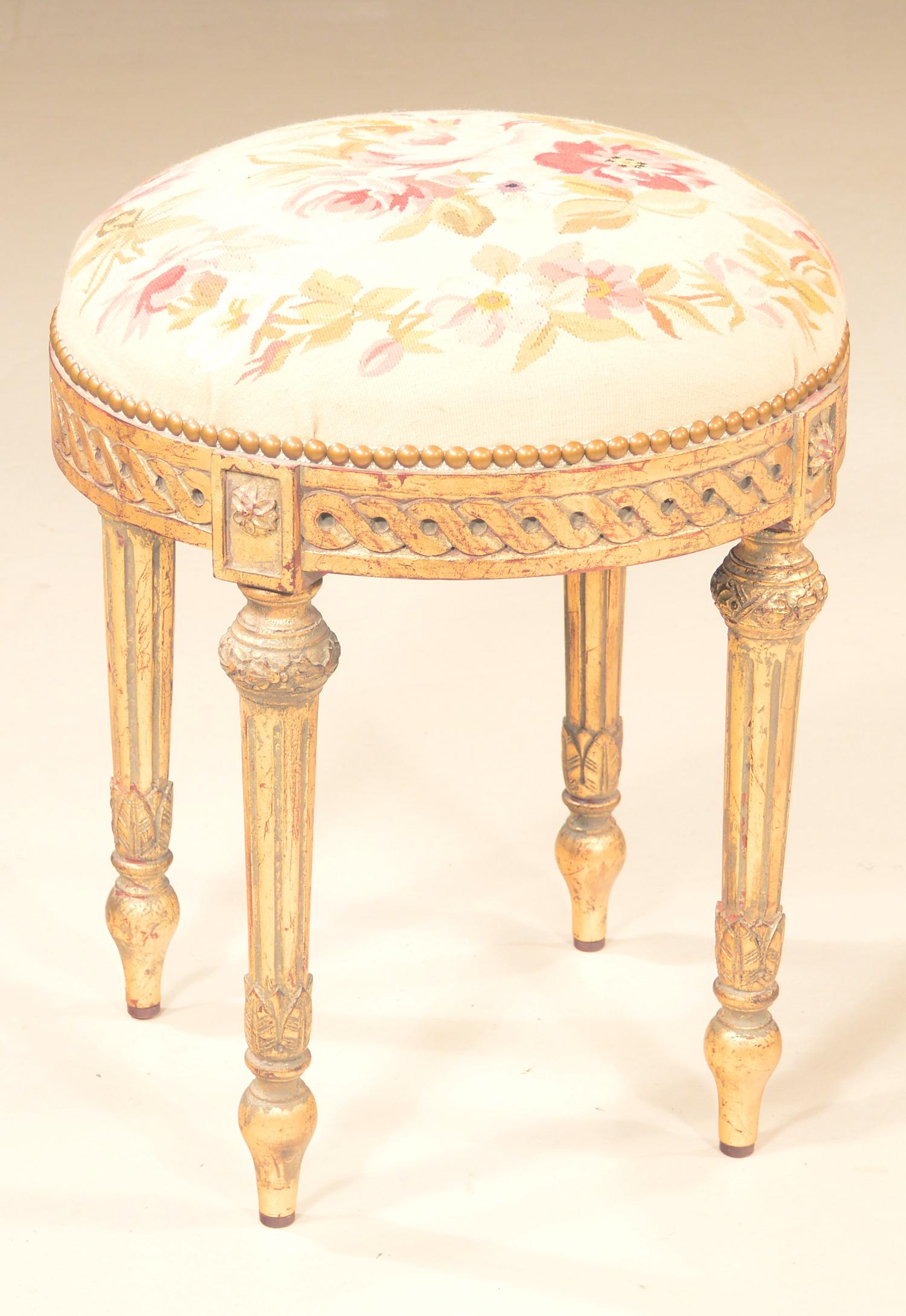 Gilt circular foot stool: Circular Louis XVI style gilt foot stool with upholstered seat, carved apron and on tapered fluted legs, 16" diameter, 20" high