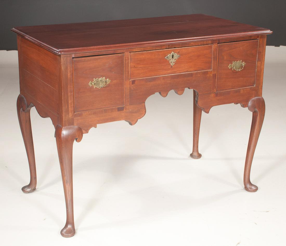 Queen Anne style mahogany lowboy: Queen Anne style mahogany lowboy with a deep drawer on each end and a long drawer in the center, having shaped apron and on cabriole legs with pad feet, c.1900, 42" wide, 23" deep, 32" high
