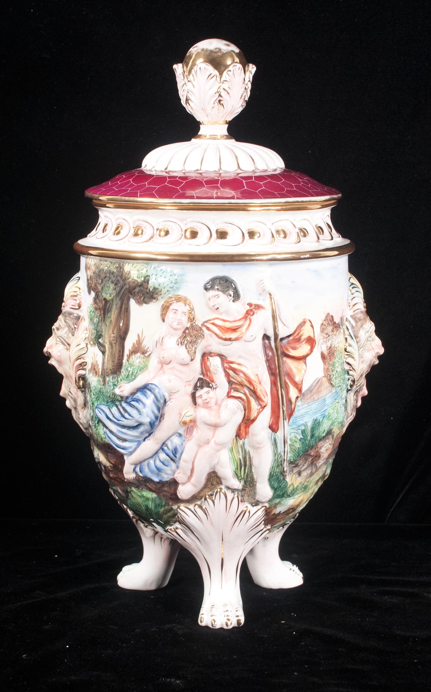Capo di Monte porcelain covered urn: Capo di Monte porcelain covered urn with raised scenic and figural decorations, mask handles on the sides and on hairy paw feet, 17" high