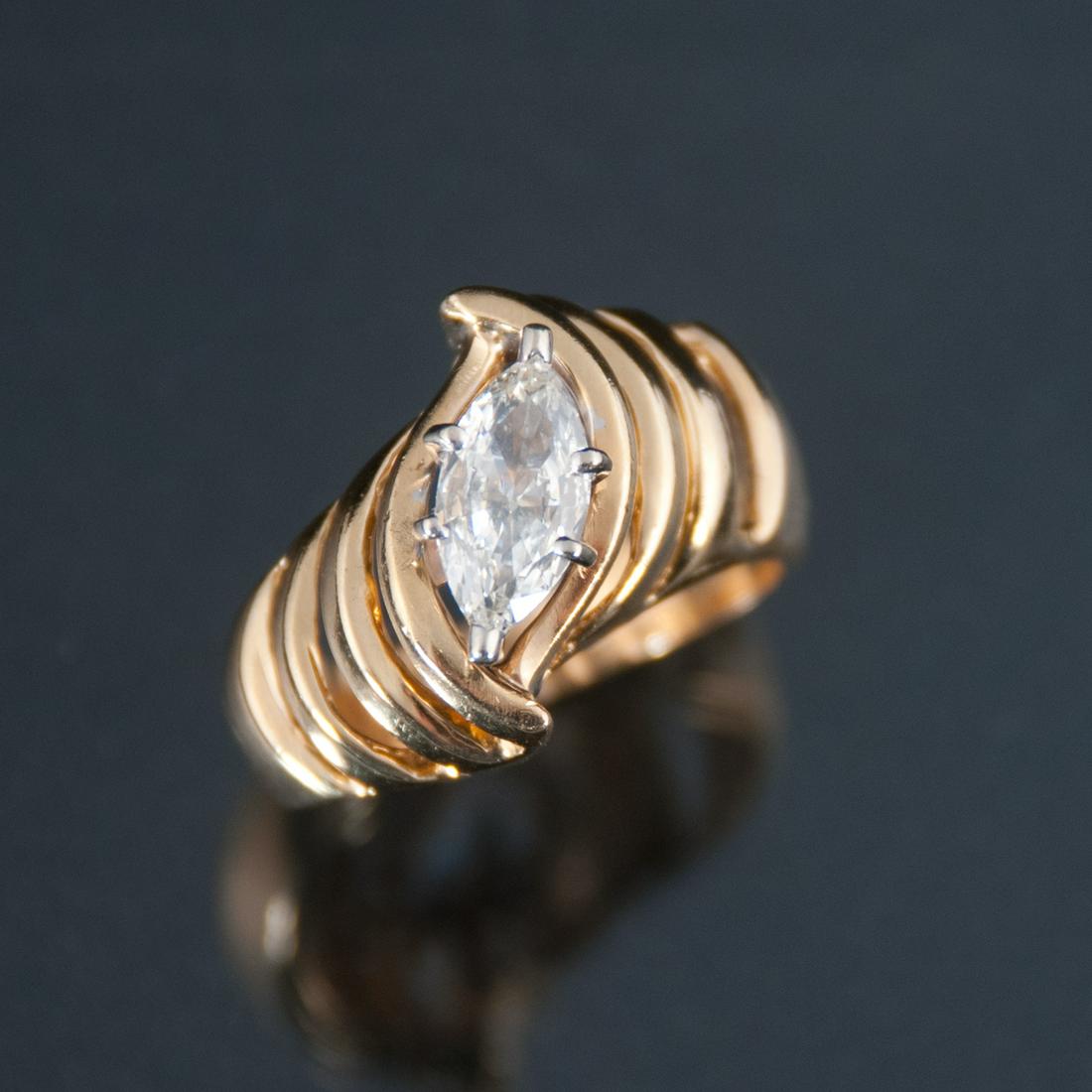 14K ring with marquise diamond: 14K yellow gold ring with one center marquise cut diamond, approx. 1.00 cts in a swirl setting, diamond is H color, SI1 clarity