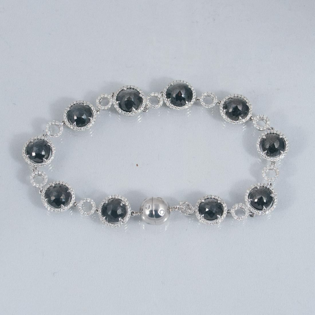 7.5" 18K white gold black diamond bracelet: 7.5" 18K white gold black diamond bracelet, consisting of 10 round black diamonds weighing 15.00 cts and completed with 410 round white diamonds weighing 2.50 cts
