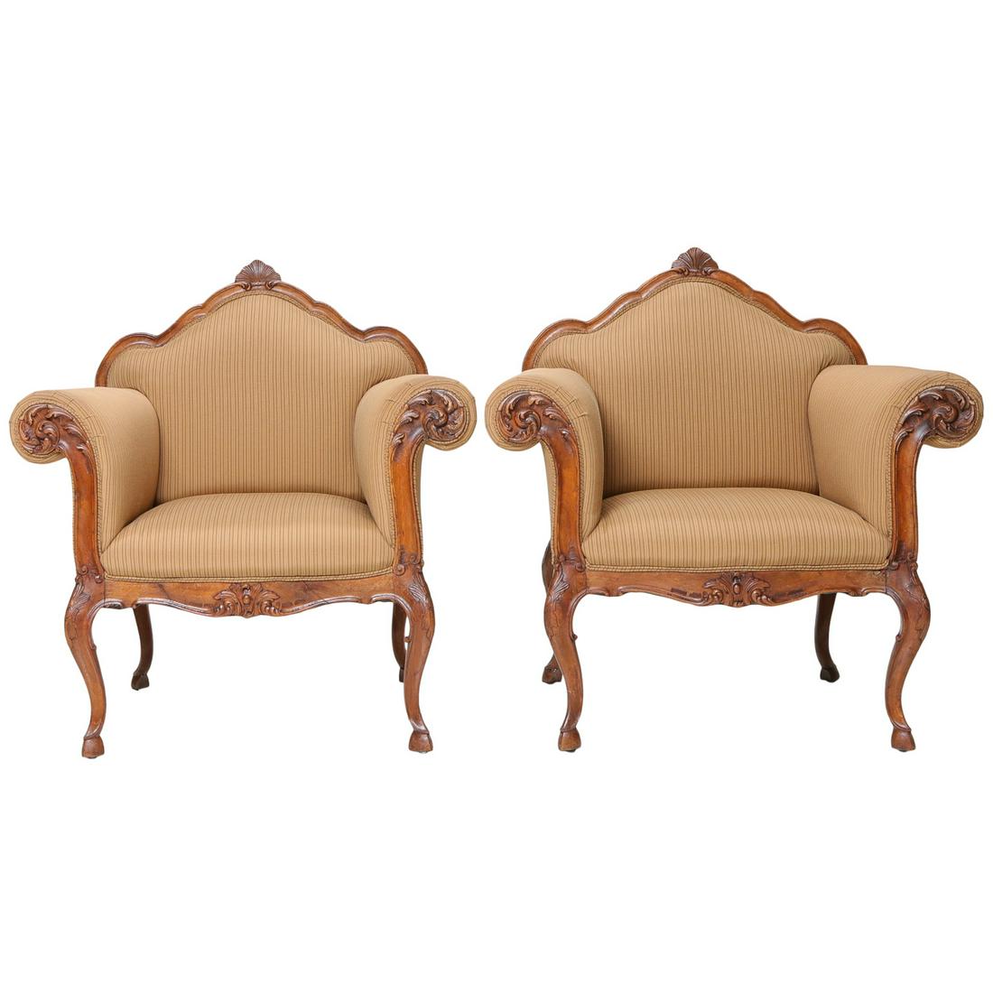 Antique Italian Walnut Armchairs with Shaped Backs: Antique Italian Walnut Armchairs with Shaped Backs Having Shell Carvings, Roll Over Arms with Leaf Carved Fronts and Shaped Carved Apron on Cabriole Legs with Hoof Feet, C. 1890-1900. 36" Wide, 25" De