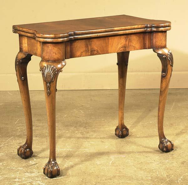 Georgian walnut lift top game table on cabriole l: Georgian walnut lift top game table on cabriole legs with shell carved knees and ball and claw feet, c.1890, 33" wide, 17" deep, 29" high