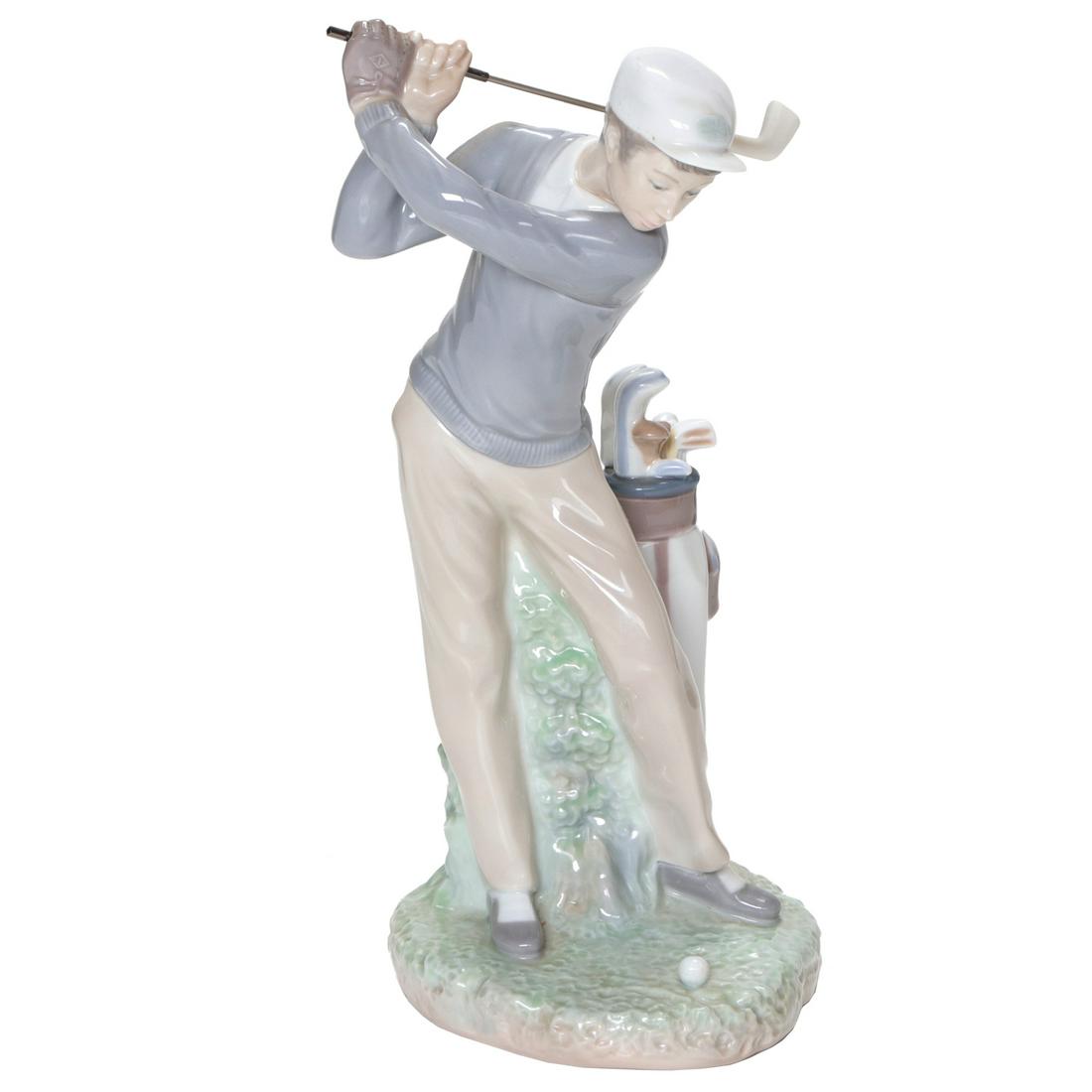 Lladro Porcelain Figure of a Golfer: Lladro Porcelain Figure of a Golfer Swinging a Club with Bag by His Side. 11" High. As Found (Small Chip to Club Head)