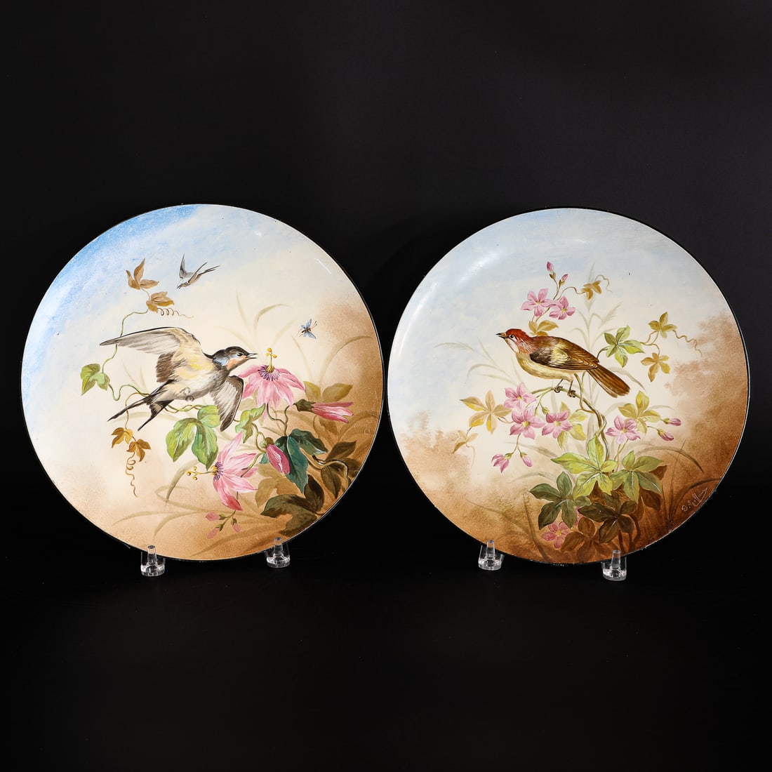 French Style Porcelain Circular Chargers Featuring Floral and Bird Decorations, Pair: French Style Porcelain Circular Chargers Featuring Floral and Bird Decorations, Pair, Having Ebony Rims, Central Birds Surrounded by Pink Flowers and Green Leaves, in Natural Setting, Signed Lower Rig