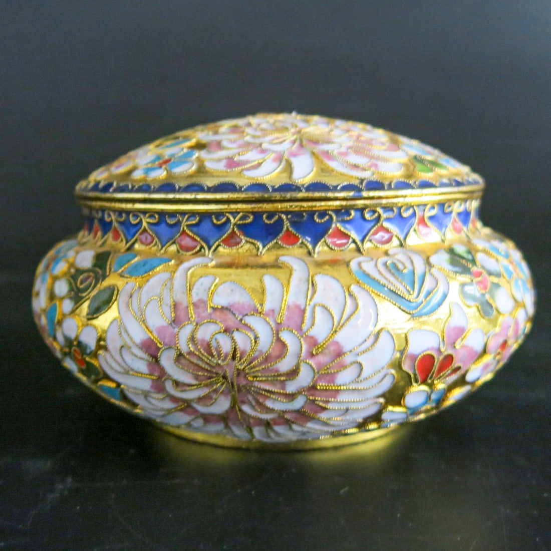 Circular Cloisonne Style Box with Lid: Circular Cloisonne Style Box with Lid, Having Multi Color Floral Decorations and Gold Accents, Lid Reveals Turquoise Interor.6.5" Diameter, 4" High